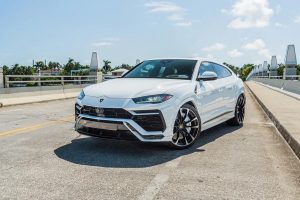white lamborghini urus suv left side view