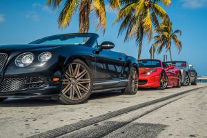 lined up cars red ferrari side view