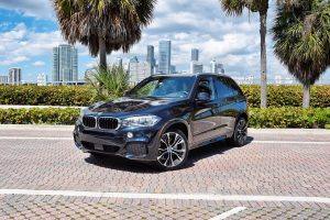Image of blue BMW x5 being rented in Brickell buy Rent & Paradise Exotic & Luxury Car Rental