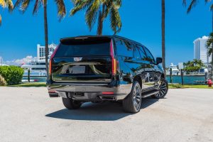 back view of black Cadillac Escalade rental car in South Beach by Rent & Paradise Exotic & Luxury Car Rental