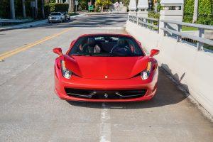 red ferrari 458 italia front view on Mc Carter Causeway Miami Beach