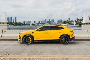 yellow lamborghini urus parked in South Beach available for rent
