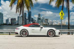 white porsche 911 carrera s (992) side view top on