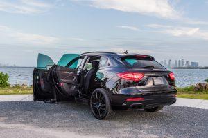 black maserati levante side view doors open