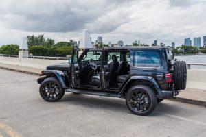 black jeep wrangler rental in Miami from a side view doors open