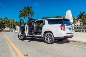 white chevy suburban side view doors open