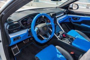 white lamborghini urus blue interior driver seat