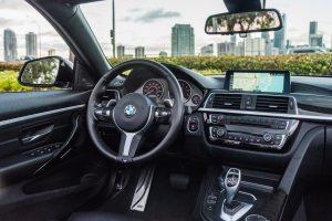 white bmw 440i center console of rental car
