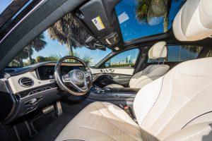 black mercedes benz s550 sedan cream leather driver seat