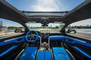 white Lamborghini urus with blue front interior thats available for rent in Miami