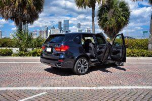 blue bmw x5 side view doors open