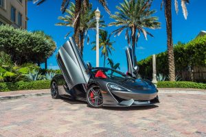 Mclaren 570s Gray with doors open at nikki beach on south beach, FL