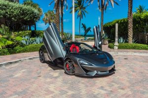 Mclaren 570s Gray with doors open at nikki beach on south beach, FL