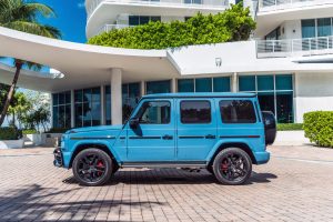 Image of left side of blue Mercedes Benz G63 AMG rental in Miami Beach by Rent & Paradise Exotic & Luxury Car Rental.