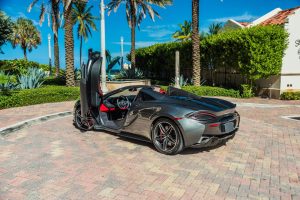 Image of left back side of grey Mclaren 570s rental in South Beach by Rent & Paradise Exotic & Luxury Car Rental.